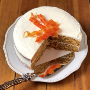 Carrot cake with cream cheese frosting and serving knife