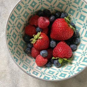 Strawberries, raspberries, and blueberries in a bowl
