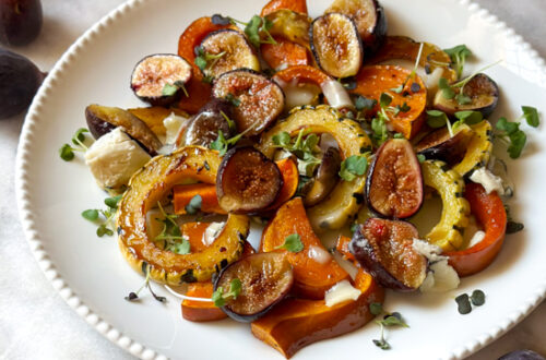 Maple roasted squash and roasted figs on plate with microgreens and cheese