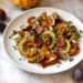 Maple roasted squash and roasted figs on plate with microgreens and cheese