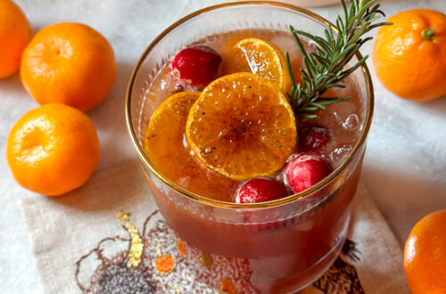 Cranberry orange mocktail with ginger and garnished with rosemary