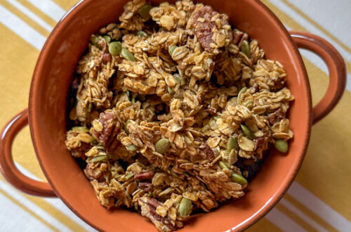 pumpkin granola in an orange bowl