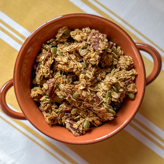 pumpkin granola in an orange bowl