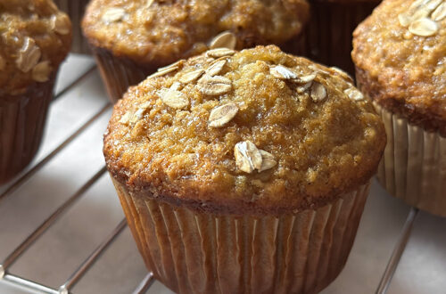 honey nut banana muffins cooling on a wire rack on kitchen counter