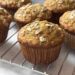 honey nut banana muffins cooling on a wire rack on kitchen counter