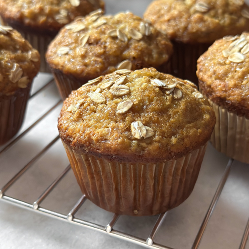 honey nut banana muffins cooling on a wire rack on kitchen counter