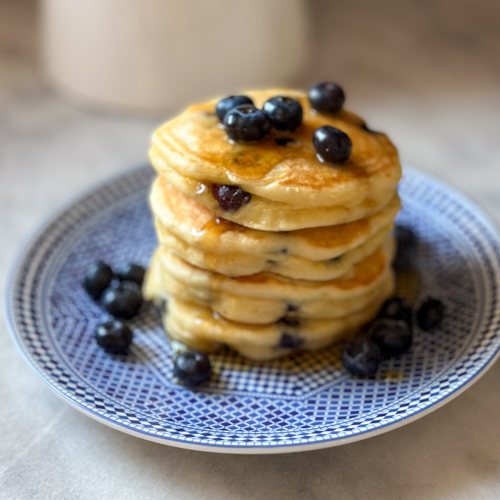 fluffy blueberry pancakes drizzled with maple syrup