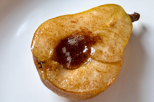baked maple pear on a white plate