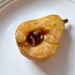 baked maple pear on a white plate